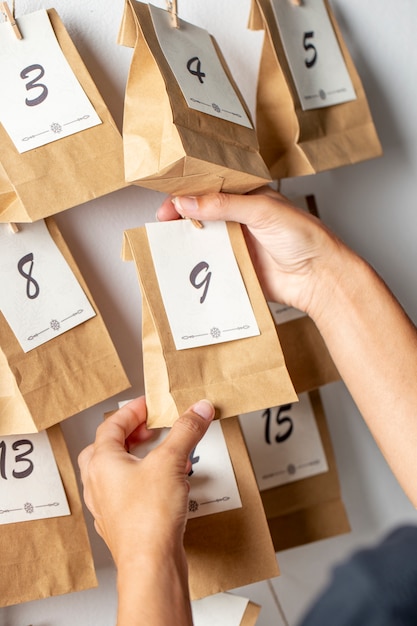 Hands holding small paper bag high angle