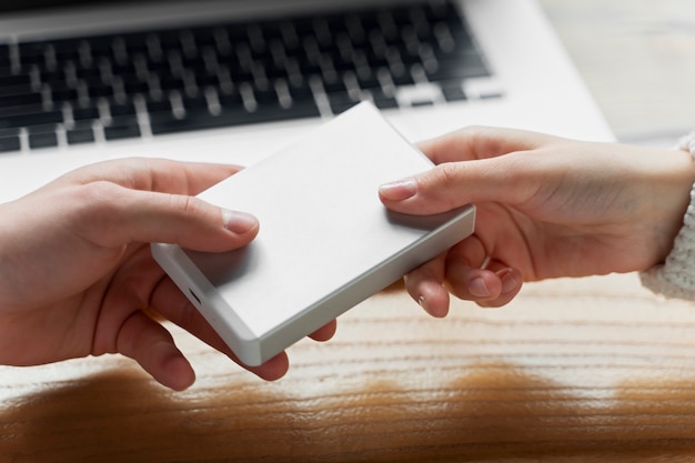 Free photo hands holding ssd device close up