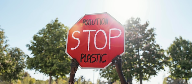 Free photo hands holding stop sign close up