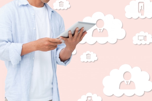 Free Photo hands holding a tablet with clouds in the background