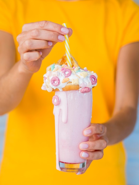 Free photo hands holding tasty pink milkshake