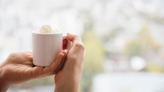 Hands holding teacup