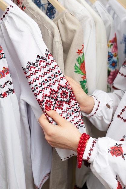 Hands holding traditional embroidered shirt