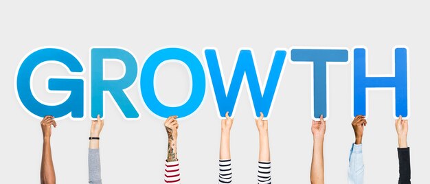 Hands holding up blue letters forming the word growth