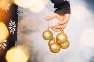 Free photo hands holding various christmas balls