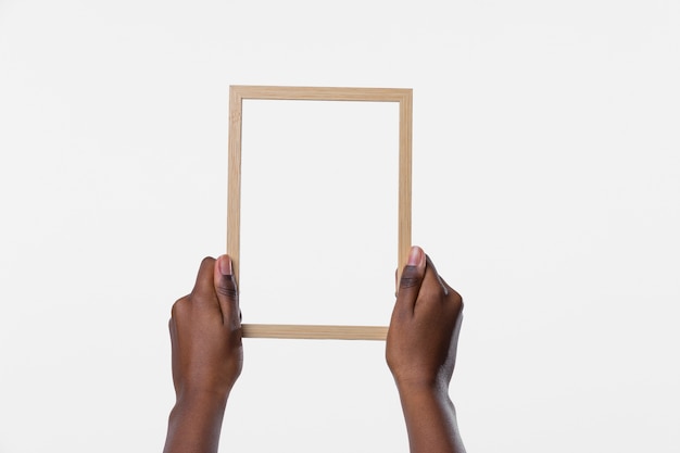 Hands holding wooden frame