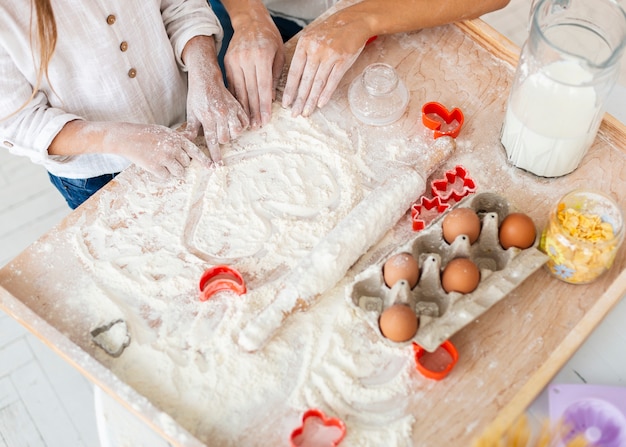 Hands making a hearth from flour