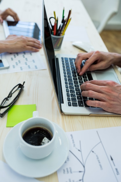 Hands of male graphic designer using laptop