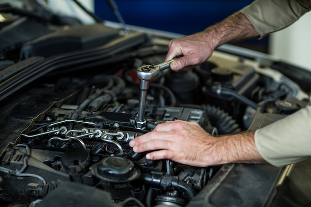 Hands of mechanic servicing a car