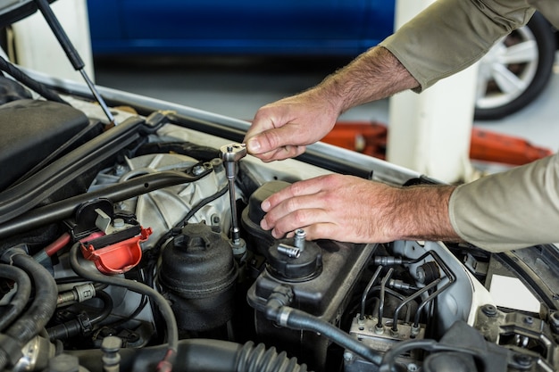 Free Photo hands of mechanic servicing a car