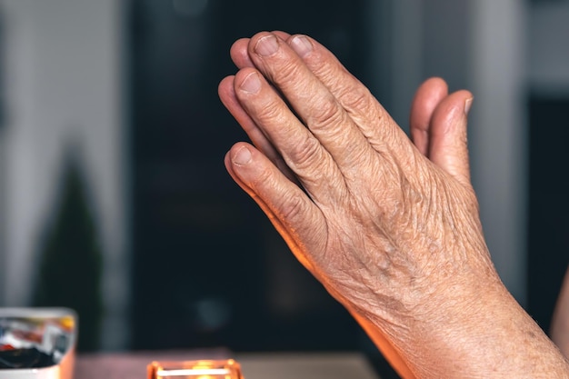 Free photo hands of an old woman folded for prayer