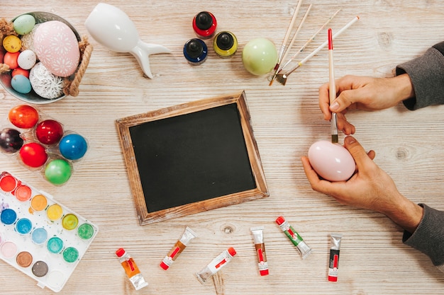 Free photo hands painting easter egg in workshop