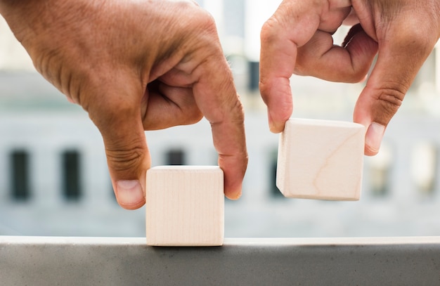 Hands placing cubes on surface