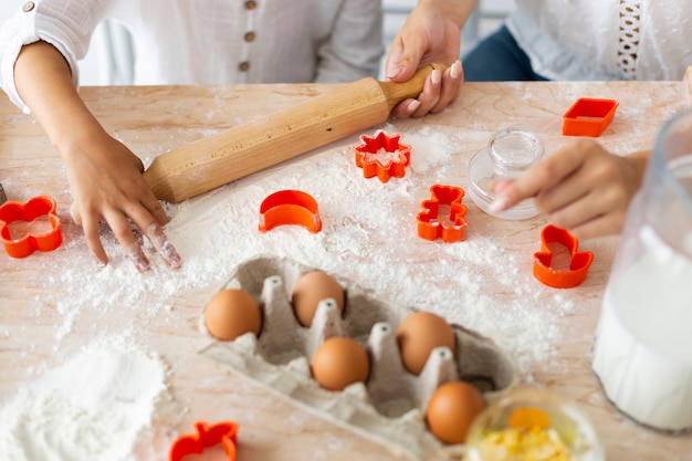 Hands preparing cookies with kitchen roller