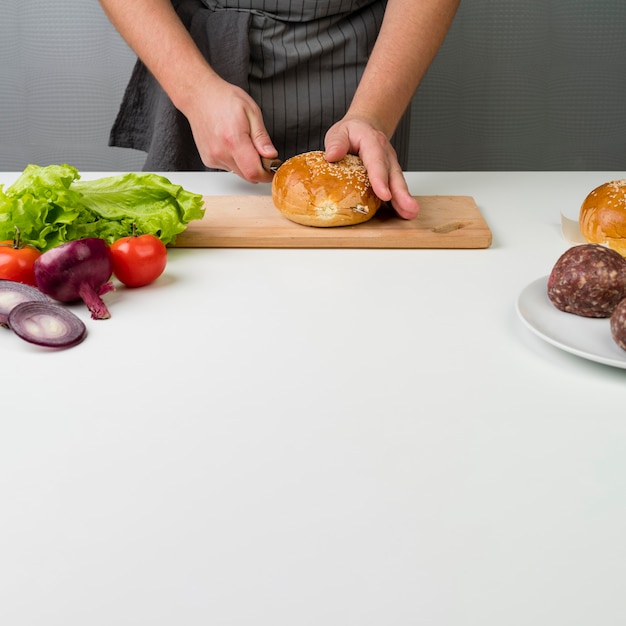 Hands preparing a delicious burger