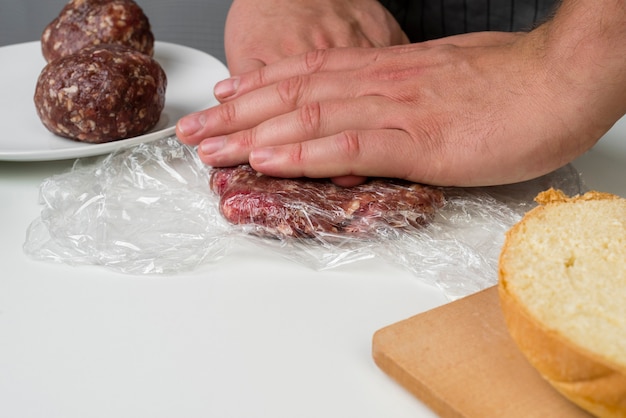 Free photo hands preparing meat for hamburger