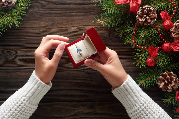 Hands putting a ring in a red box