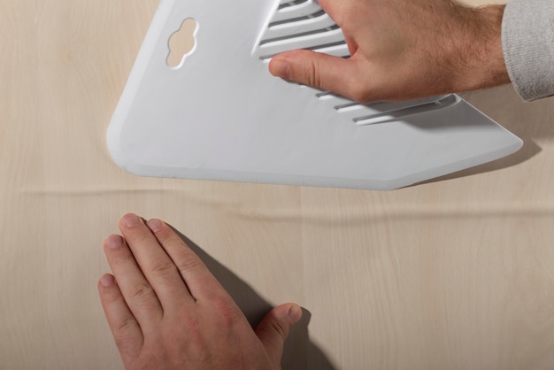 Hands putting up decorative vinyl top view