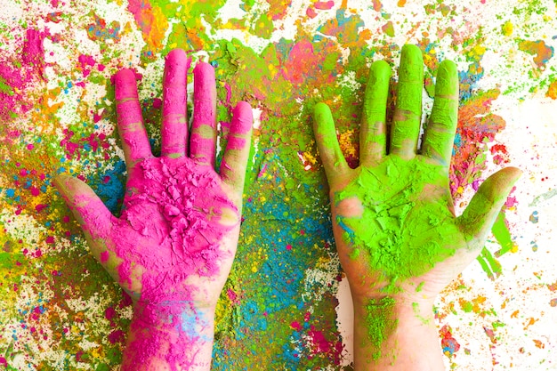 Hands in rose and green colors on bright dry colours