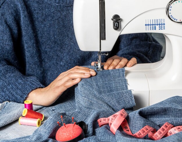 Hands sewing with machine close-up