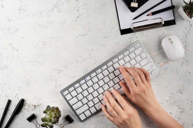 Hands typing on keyboard