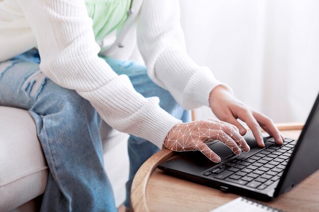 Hands typing on laptop keyboard