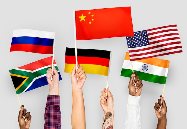 Free photo hands waving flags of china, germany, india, south africa, and russia