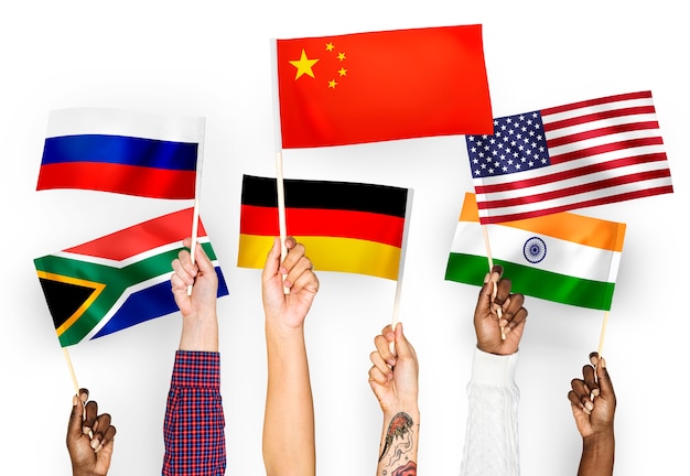 Hands waving flags of China, Germany, India, South Africa, and Russia