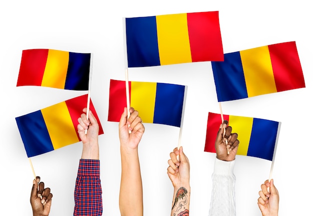 Free photo hands waving flags of romania