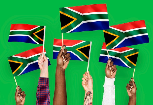 Free photo hands waving flags of south africa