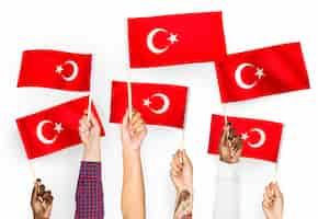 Free photo hands waving flags of turkey