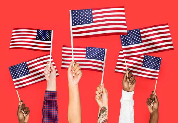 Hands waving flags of the United States