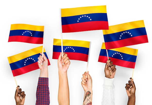 Hands waving flags of Venezuela