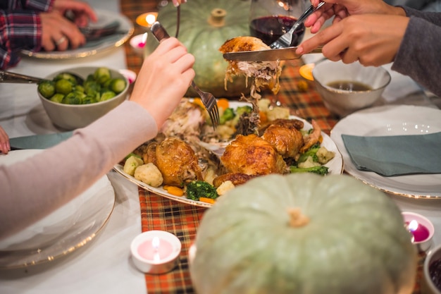 Hands with forks taking meat