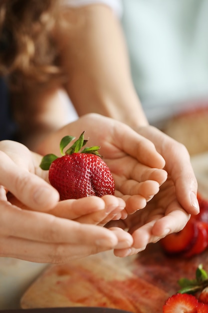 Free Photo hands with fresh strawberries