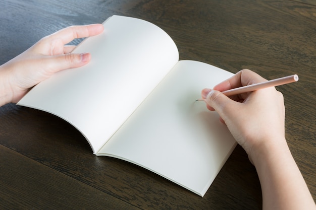 Hands with an open blank pad and a pencil