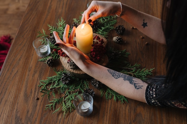 Hands of woman lighting a candle