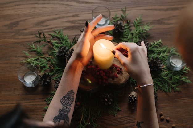 Hands of woman lighting a candle