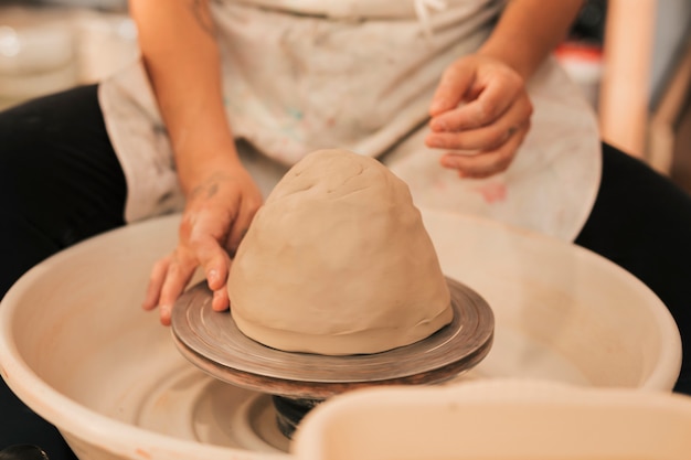 Free photo hands working on pottery wheel