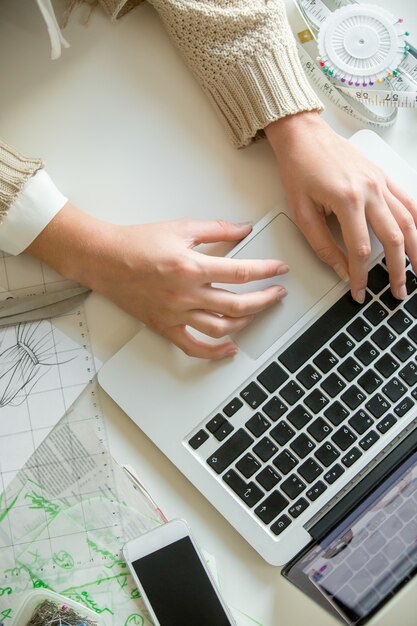 Hands working with a laptop