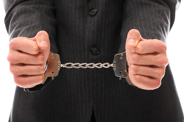 Free photo hands of young man in handcuffs