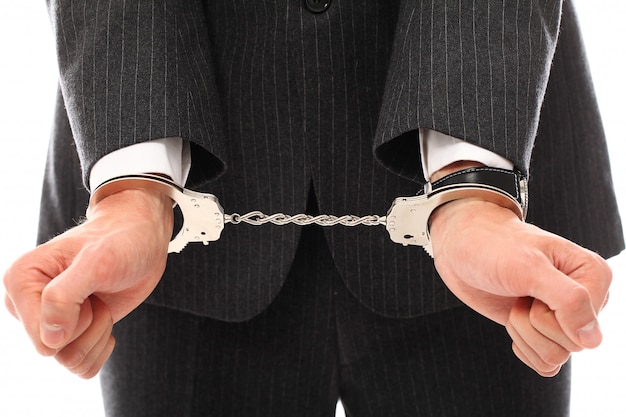 Free photo hands of young man in handcuffs