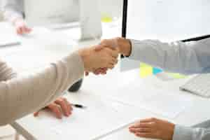 Free photo handshake of man and woman after signing business contract, closeup