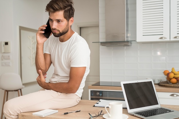 Handsome adult male talking on the phone