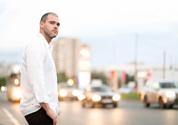 Handsome adult male waiting for the bus