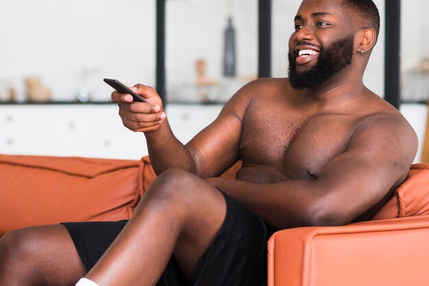 Handsome adult male watching tv