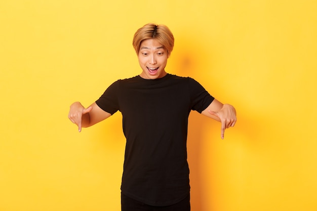 Free photo handsome asian blond guy posing