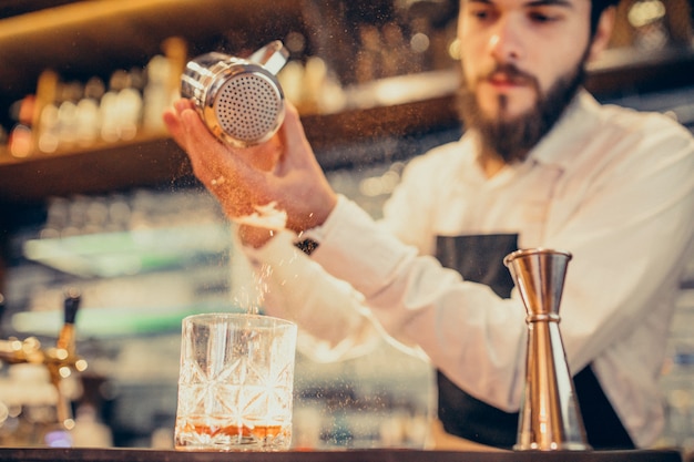 Free Photo handsome bartender making drinking and cocktails at a counter