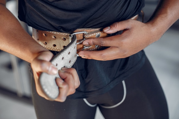 Free photo a handsome black man is engaged in a gym