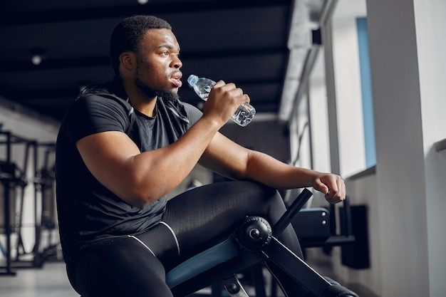 A handsome black man is engaged in a gym